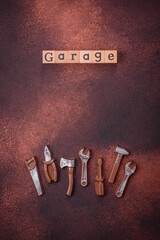 Tools and inscriptions symbolizing repairs or a garage and its attributes on a plain background
