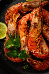 Langoustines, Australian, freshly frozen on ice, top view, lime and greens,
