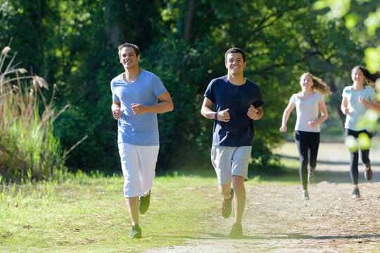 competitors running in a forest at an endurance event