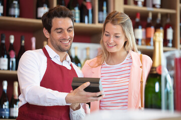 male seller showing calculator to female customer