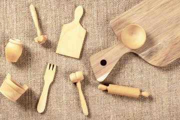 Rustic Top View Display of Wooden Kitchenware on Burlap Background