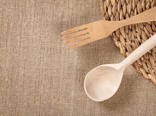 Top View of Eco-Friendly Wooden Kitchen Utensils on Rustic Burlap Background