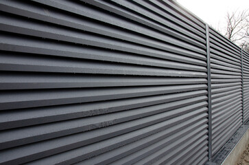Modern metal fence with shutters