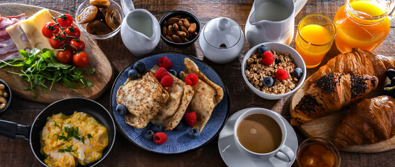 Breakfast served with coffee, eggs, cereals nd croissants - obrazy, fototapety, plakaty