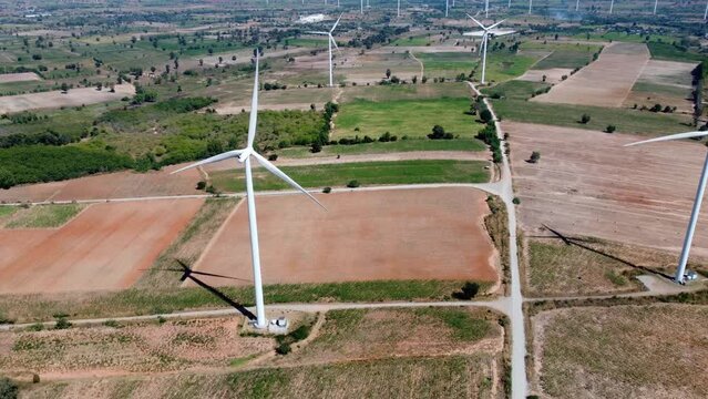 An aerial picture of a contemporary wind farm in motion that produces electricity. It is an example of environmental conservation and innovation in the electric business, and it is clean and renewable