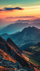 A panoramic view of a majestic mountain range with a colorful sunrise