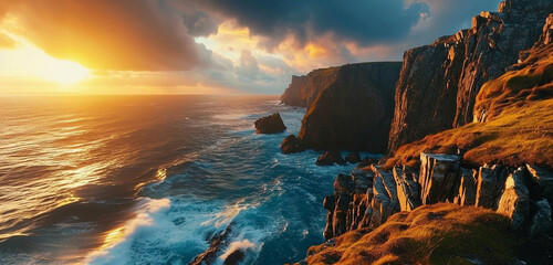 A panoramic view of a rugged coastline with cliffs and a dramatic sunset over the ocean