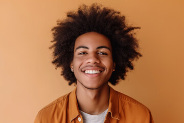 Obraz na płótnie Canvas african-american boy smiling on orange background