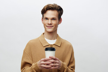 Confident Young Businessman Enjoying a Hot Cup of Coffee in a Modern Studio