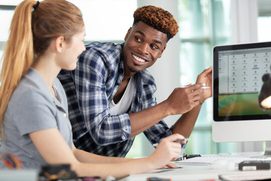 young male and female it specialist in the office