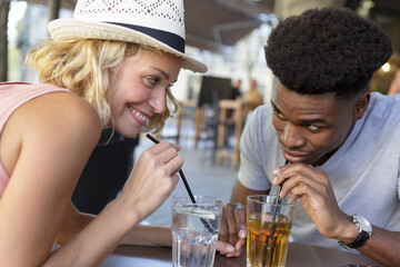 happy mixed couple having a cocktail during holidays