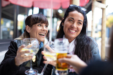 happy friends drinking beer in the pub