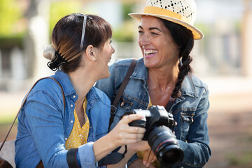 women watching photos in a digital camera