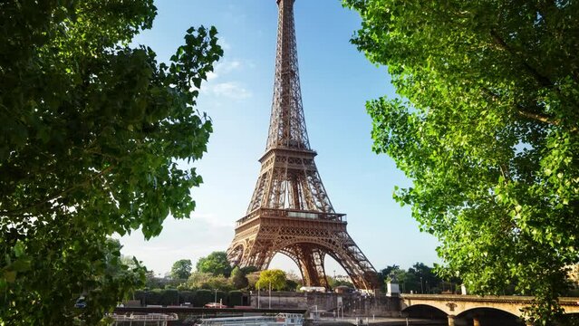 Eiffel Tower. People on Champ de Mars. World famous symbol of Paris at sunset. Popular tourist destination.
