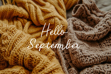 Hello September text on knitted sweaters background. Hello September concept