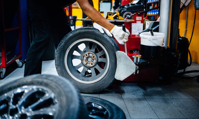 Close-up of a mechanic holding a tire changing device To change new tires.