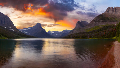 Fototapeta na wymiar Scenic Sunrise Over Glacier Lake with American Rocky Mountain Landscape in the Background. Breathtaking Panoramic View Captured in Glacier National Park, Montana, United States