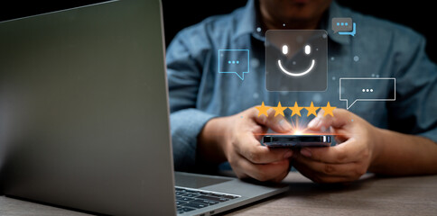 human hand using smartphone with pop-up five star icon for feedback service satisfaction Customer Service Experience and Business Satisfaction Surveys Communication and giving good advice to customers