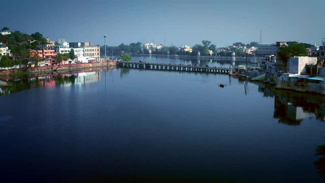Aerial shot of Udaipur lake with bridge and surrounding ghats. Rajasthan, India.