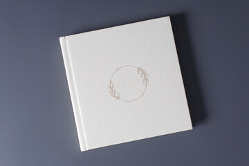 closed beige photo album with empty cover on gray background with copy space for text. white photo...