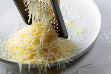 Grated cheese and grater.
