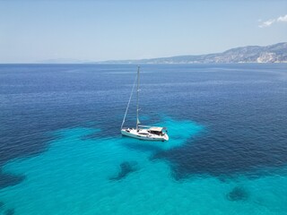 Drone view of the yacht sailing in the Ionian sea near Fteri beach, Kefalonia island, Greece