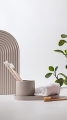 Bamboo toothbrushes in a stylish concrete glass on a white background