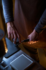 Process of making coffee tamping freshly ground coffee beans in portafilter