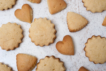 Homemade cookies of different shapes - hearts, stars and triangles, top view close up