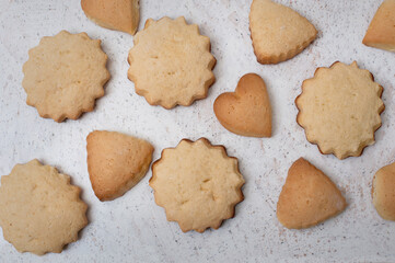Homemade cookies of different shapes on white marble texture