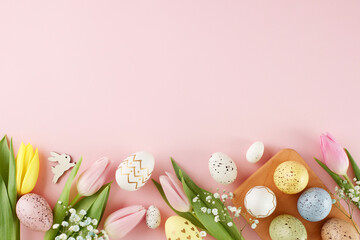 Easter-themed decor concept. Top view photo of colorful eggs, fresh flowers, easter bunnies on...