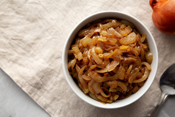 Organic Caramelized Onions in a Bowl, top view. Flat lay, overhead, from above. Copy space.
