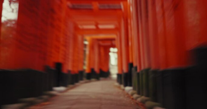 Spiritual, path and time lapse in tori gates with travel, adventure and journey in Shinto shrine in Kyoto. Fast, tour and Fushimi Inari Taisha in Japan for religion, culture and history monument