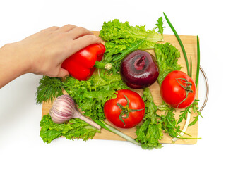 Vegetable still life. Tomatoes, garlic, onion, pepper, greens. The chef prepares vegetable dinner.