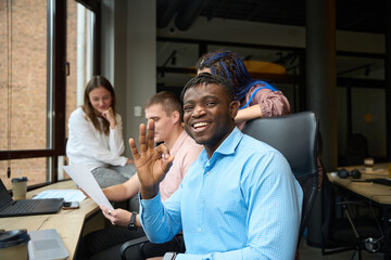 Cheerful African American man showing ok hand gesture looking at camera