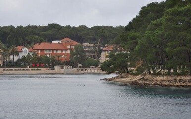 Beautiful boutique hotels by sea. Cikat, Island of Losinj, Croatia. Cikat forest park beach with trees and the blue sea .