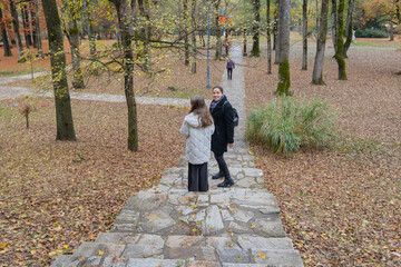 Fototapeta premium Peaceful scene of family enjoying autumn park, relaxing outdoors together.