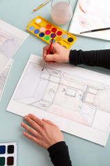 Interior designer is working on color hand drawing of bathroom using watercolor paints and brush - 708058437