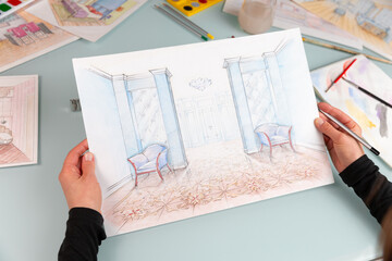 Interior designer holding a color hand drawing of comfortable sitting room at work place