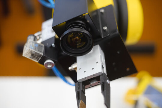 A robot in a factory equipped with a machine vision camera.