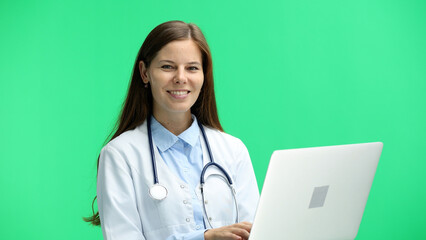 Female doctor, close-up, on a green background, with a laptop