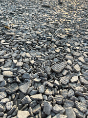 Small road stone background. Gravel pebbles stone texture. Seamless texture