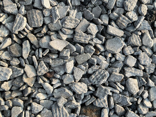 Small road stone background. Gravel pebbles stone texture. Seamless texture