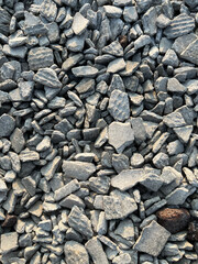 Small road stone background. Gravel pebbles stone texture. Seamless texture