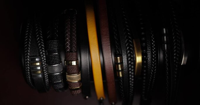Collection of leather bracelets illuminated by moving light