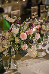 long table setting with multi color flower arrangement for wedding decoration and private party with family in a sunny day outdoors