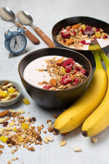 Bowl with yogurt, granola, berries, nuts and fruits. The concept of nutrition, diet, healthy breakfast. .
