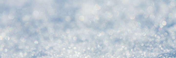 Snow surface close-up. Winter background with snow texture and beautiful bokeh. Shallow depth of...