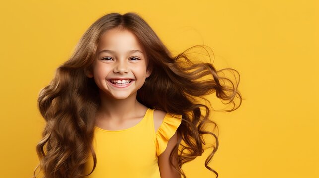 A girl who is content with her long hair and yellow background.