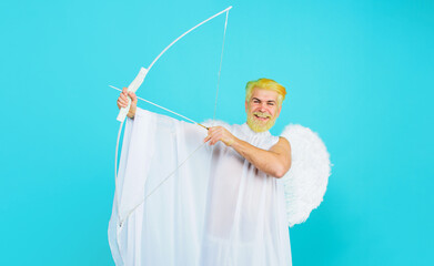 Valentine cupid angel shooting arrows of love. Smiling bearded man in angel costume with bow and...